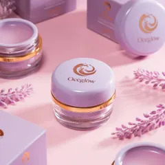 A beautifully styled flatlay of Océeglow products, surrounded by their packaging and lavender sprigs. The soft pink background and harmonious color palette create a gentle, feminine aesthetic. This type of shot is perfect for social media and website banners.