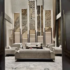 This double-height living room is a study in verticality and texture. We used towering, backlit panels with organic patterns to draw the eye upward, creating a sense of grandeur, while the plush, contemporary sofas arranged for conversation provide a grounded, comfortable core to the space.