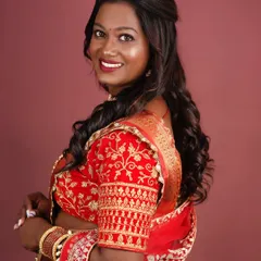 A side profile of the finished look, showing the soft curls and the way the makeup complements her skin tone.