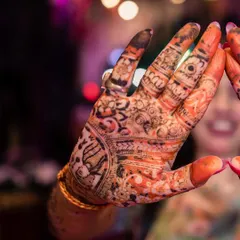 A close-up shot focusing on the intricate design of the bride's mehndi. This image celebrates a beautiful and significant tradition, capturing the artistry that is part of the bridal transformation.
