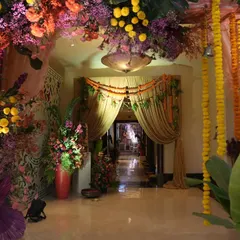 Looking through the traditional floral archway, you can see the path ahead draped in marigold garlands and curtains, building layers of festive beauty.