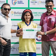 A player from our U15 girls team receives the 'Player of the Match' award at the Reliance Foundation Young Champs Football Cup. Individual excellence contributing to team success.