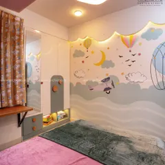This whimsical kids' room features a custom wardrobe with a built-in mirror and desk, set against a wall mural of hot air balloons and airplanes.