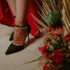 This photo shows how beautifully a henna stain on the foot can look. The rich, dark color of the mandala design stands out and looks stunning paired with elegant heels.