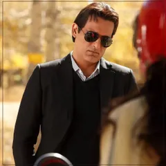 A candid shot of actor Akshaye Khanna wearing a custom black suit. This demonstrates the versatility and effortless style of my tailored pieces, suitable for any setting.