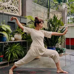 Here I am demonstrating a Tai Chi posture, a practice I call moving meditation. This ancient art is about finding focus and internal strength through slow, deliberate movement. It is an excellent way to ground your energy and reset your nervous system, especially if you find it difficult to sit still.