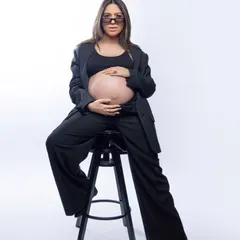 Serving some serious 'Boss Mama' energy! This modern, confident portrait in a chic black suit shows a different side of maternity style. It's all about celebrating your power and embracing this new chapter with confidence.