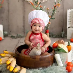 Meet the cutest little chef in town! This six-month milestone session was a fun, food-themed shoot complete with a chef's hat and fresh veggies.