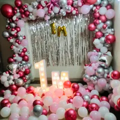 This extravagant floor-to-ceiling balloon decoration is perfect for making a huge impact. Featuring a shimmer backdrop, marquee letters, and hundreds of balloons, this style can be customized for a major anniversary milestone.