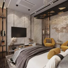 A view of the media wall in the same Lucknow master bedroom, showcasing integrated shelving and a seamless design. The space is perfect for unwinding, with a comfortable seating area and layers of sophisticated materials.