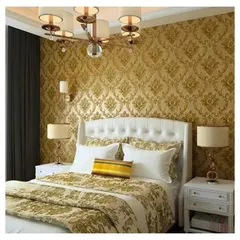 A luxurious bedroom featuring a gold-on-gold embossed damask wallpaper, creating a regal and opulent atmosphere.