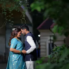 A quiet, intimate portrait of a couple standing forehead to forehead under natural foliage. This kind of shot is perfect for capturing the peaceful, loving connection between two people.