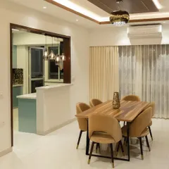 Our client envisioned a dining area that was both functional and inviting. We created an open-concept layout connecting to the kitchen, with a modern wooden table, plush chairs, and a breakfast bar for a spacious and connected feel.