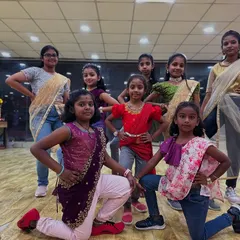 My girl gang dressed in traditional wear, striking a pose. We teach them how to be confident performers.