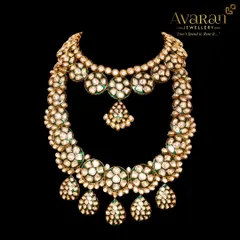 A grand, layered Polki bridal set, featuring a choker and a long necklace. This is the ultimate statement piece for a royal wedding look.