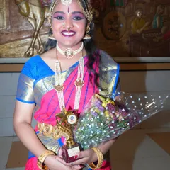 A proud moment for the artist, holding her trophy and bouquet after a successful performance. I make sure to capture these moments of achievement and celebration.