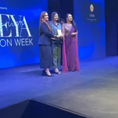 On stage at Seeya Fashion Week, receiving an award with my team. This recognition is a testament to our hard work and dedication to style.