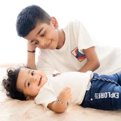 A candid moment where an older brother looks lovingly at his baby brother. These unposed shots are perfect for capturing the real emotions of childhood.