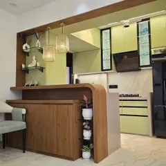 This open-concept kitchen features a lime-green and wood finish, connected to a custom bar unit. It's a perfect example of how we blend the kitchen into the living space, creating a multi-functional area for cooking and socializing.