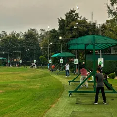 A bustling Sunday at the range, with golfers of all ages and skill levels practicing side by side.