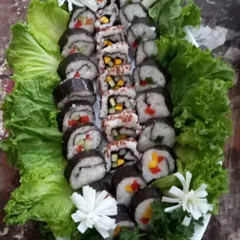 A platter of my handcrafted vegetarian sushi, beautifully presented on a bed of fresh lettuce. This is part of my fusion catering menu, offering a taste of global cuisine made with 100% vegetarian ingredients.