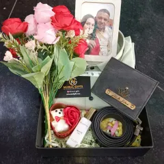 A truly personal and romantic gift. This anniversary hamper includes a shirt, a personalized wallet and belt, perfume, flowers, and a custom photo frame to capture a special memory.