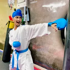 The Kiai, or martial arts shout, is used to focus energy and power into a single strike. Here, I'm practicing a Gyaku-zuki (reverse punch) on the heavy bag, a fundamental power shot in Kumite.