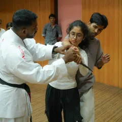 This is a close-up view of a knife defense drill. We teach students how to control the weapon-bearing limb and create leverage to neutralize the threat safely and efficiently.