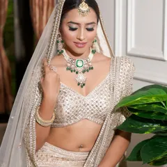 This look blends tradition with modern sophistication. I created subtle smokey eyes and gave her naturally flushed skin, creating a perfect ivory canvas that lets the beautiful emerald jewellery shine.