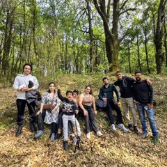 Our group taking a break during a forest hike. These are moments for real conversations and connection, away from screens and city noise.