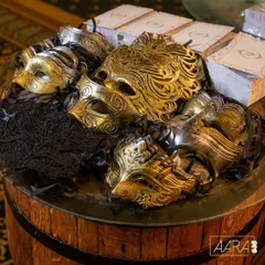 Another view of the masquerade masks, piled high on a rustic barrel. The mix of intricate gold patterns and delicate black lace provided a touch of elegance and mystery, setting the tone for the evening.