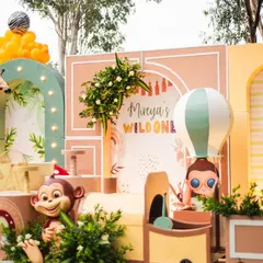 A closer look at the main stage for Mireya's boho-themed party. The design features a mix of geometric arches, a hot air balloon prop, and cute animal figures, all in a soft, earthy color palette.