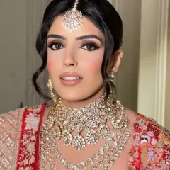A close-up showcasing the bold winged eyeliner and flawless base for this traditional bridal look. The focus is on creating sharp, defined eyes that stand out beautifully.