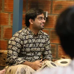 A candid shot from the 'Bhaava Sangama' concert, sharing a smile with the other artists. The camaraderie on stage is just as important as the music itself.