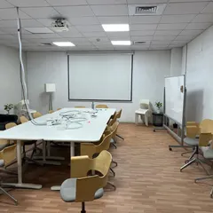 The conference room within the IKEA facility, featuring a large meeting table, projector setup, and functional seating. This space was designed and executed by our team to support collaborative meetings and presentations.