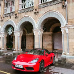 Another angle of the red Porsche, this time showing it parked next to a Starbucks in the same historic building. It’s a great example of the modern-classic blend found in Mumbai.