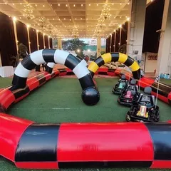 We provide a full Go-Karting experience with an inflatable track and multiple electric karts. This setup is perfect for larger spaces and provides safe, high-speed fun for kids and teens.