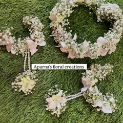 A delicate floral tiara and matching haath phool set made with baby's breath and white orchids. This is perfect for a subtle and elegant look for a Haldi or Mehendi ceremony.