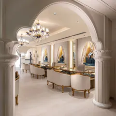 This perspective shows how classical columns and arches frame the main showroom, creating a rhythmic and elegant progression through the space. The design provides a sophisticated backdrop that enhances the display of exquisite jewellery.