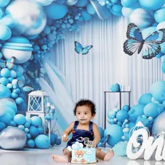 A classic cake smash portrait. With a little bit of frosting on his face, Naksha looks right at the camera, making for an adorable and memorable first birthday photo.