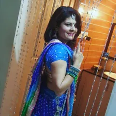 Getting ready for dandiya in a custom-made blue and green bandhani lehenga with a matching blouse and dupatta.
