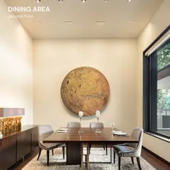 The dining area in our Vasant Vihar residence is anchored by a striking piece of art, creating a focal point for shared meals and conversations. We design spaces that are not just functional but also serve as a backdrop for life's moments, using a palette of warm, natural materials and refined finishes to build an atmosphere of quiet luxury.