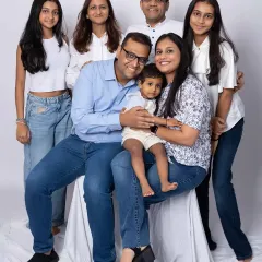 A lovely family group portrait, perfectly posed to show connection and individual personalities. The classic white and blue color scheme creates a fresh and timeless look.