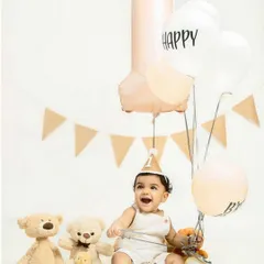 Before the smash, we take some classic first birthday portraits. Here, the birthday boy sits happily with his teddy bear friends, balloons, and a big number '1' to mark the special occasion.