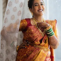 The pure joy of a bride on her wedding day. This South Indian bride's smile is radiant, enhanced by a subtle and elegant makeup application that highlights her natural beauty.