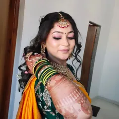 A close-up showing the detailed henna, the traditional green and yellow bangles, and the soft, radiant makeup.