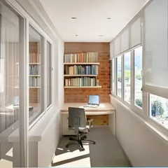 This enclosed balcony is converted into a quiet, light-filled study. The long desk provides ample workspace, while built-in bookshelves against the brick wall offer plenty of storage for a complete home office setup.