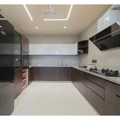 This spacious, dual-tone kitchen was designed for functionality and style. By combining dark wood grain with clean white cabinets and a clutter-free layout, I created a modern modular kitchen that is both a practical workspace and the heart of the home.