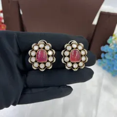 A close-up of the ruby stud earrings.