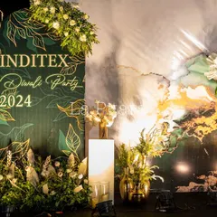 A close-up of the custom-branded backdrop for the Inditex Diwali Party 2024. The elegant design featured gold leaf illustrations on a deep green background, perfectly reflecting a modern and festive corporate style.